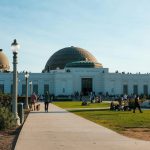 Griffith Observatory in Los Angeles on a sunny day with visitors enjoying the landmark.